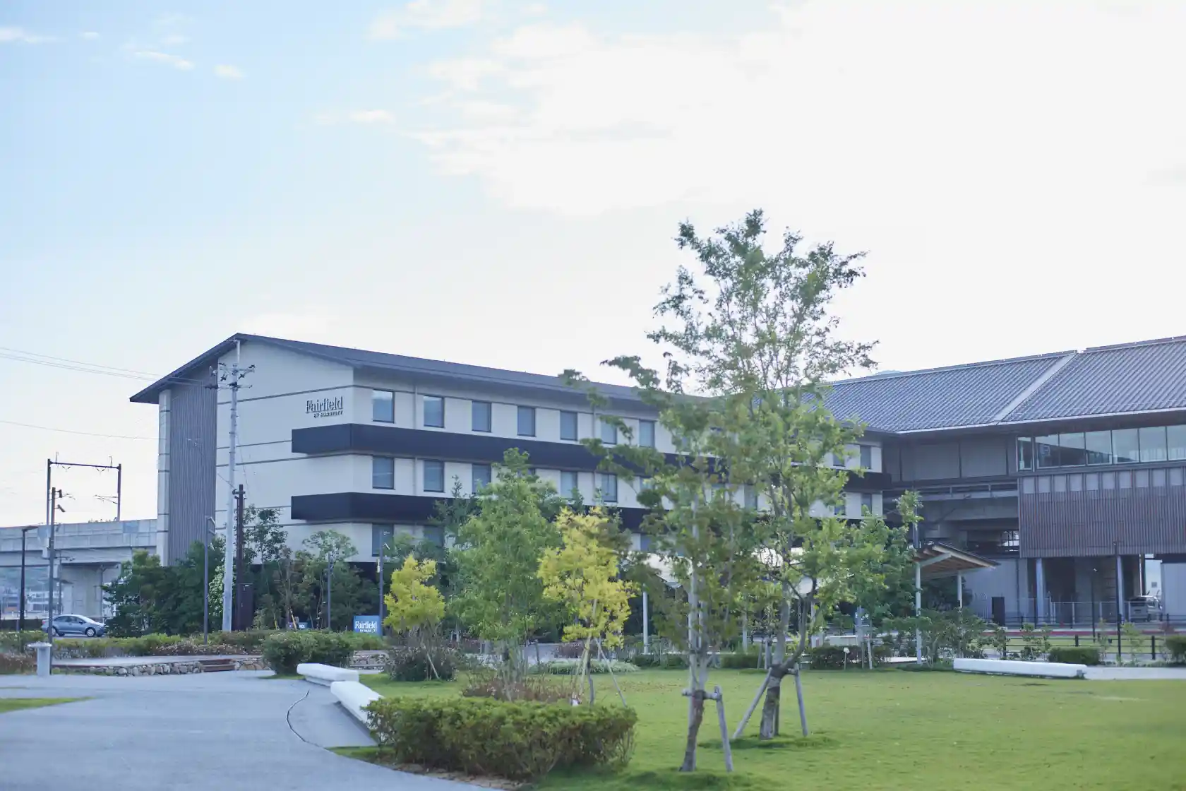 a building with trees and grass