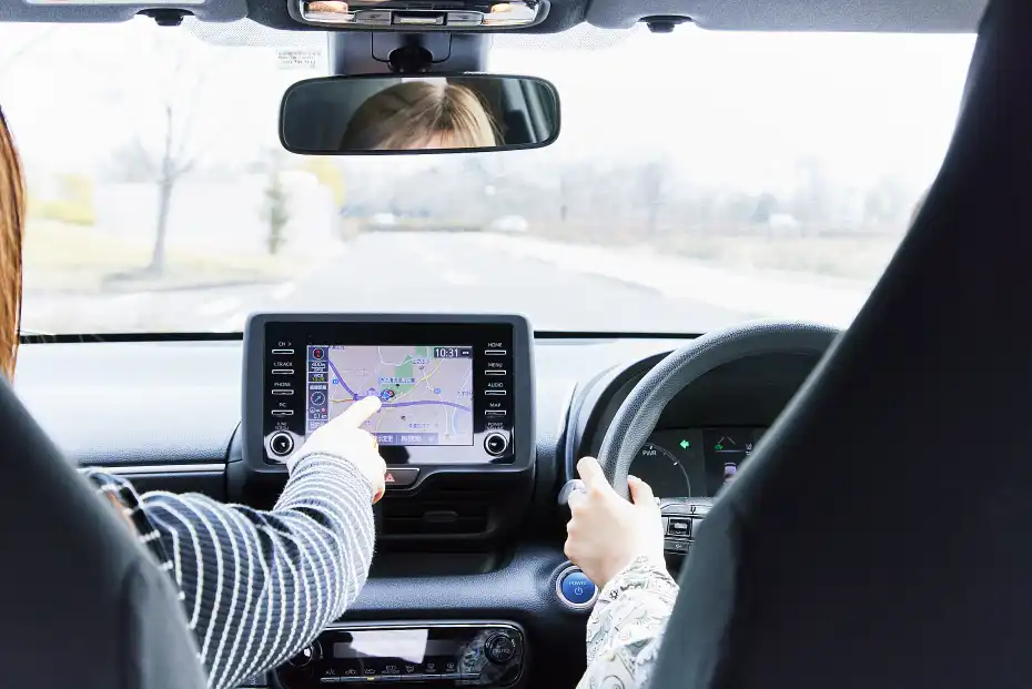 a person pointing at a map in a car
