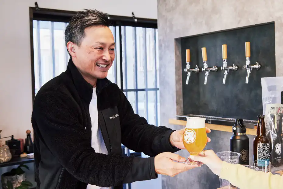a man handing a glass of beer to a woman