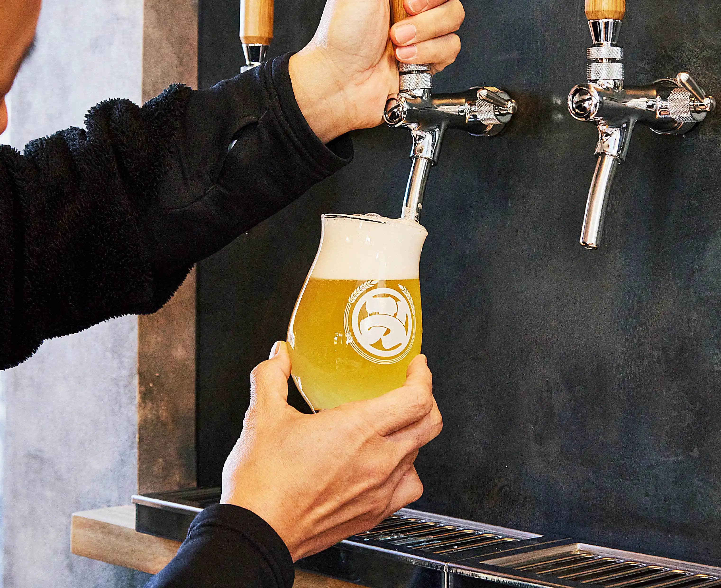 a person pouring a beer into a glass