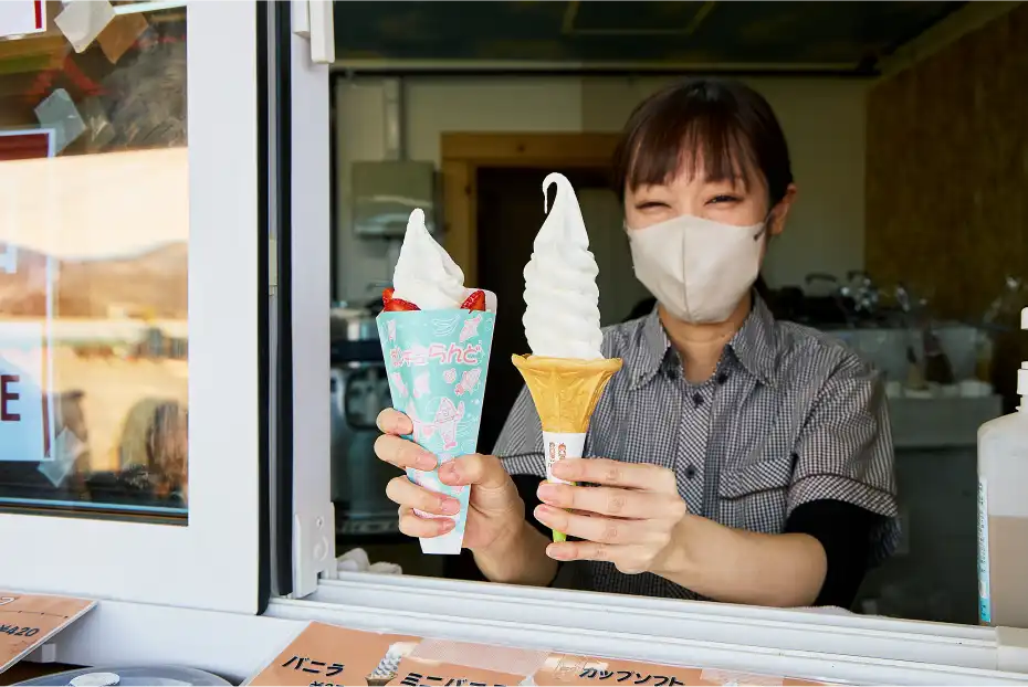 a woman holding two ice cream cones