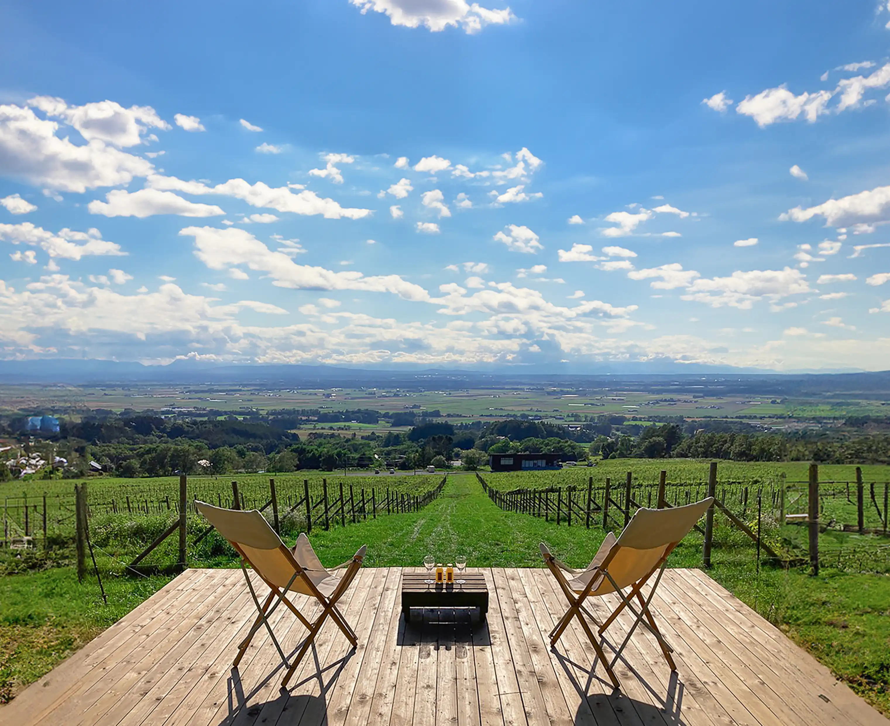 chairs on a deck overlooking a field