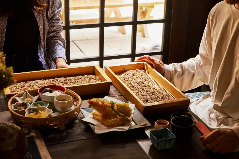 a group of people sitting at a table with food