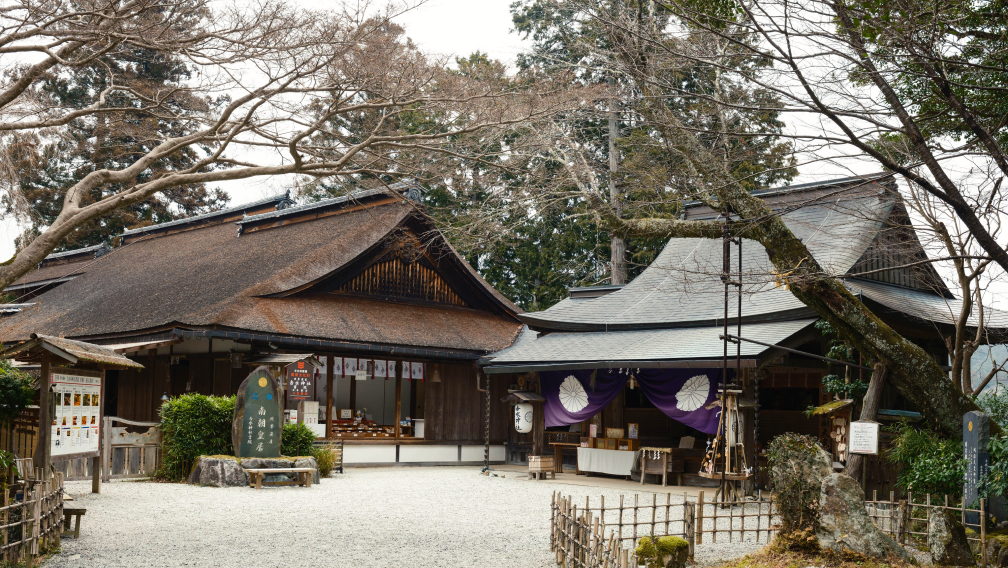 a building with a fence and trees