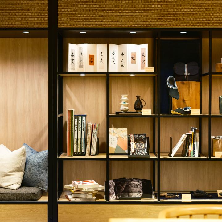 a shelf with books and pillows