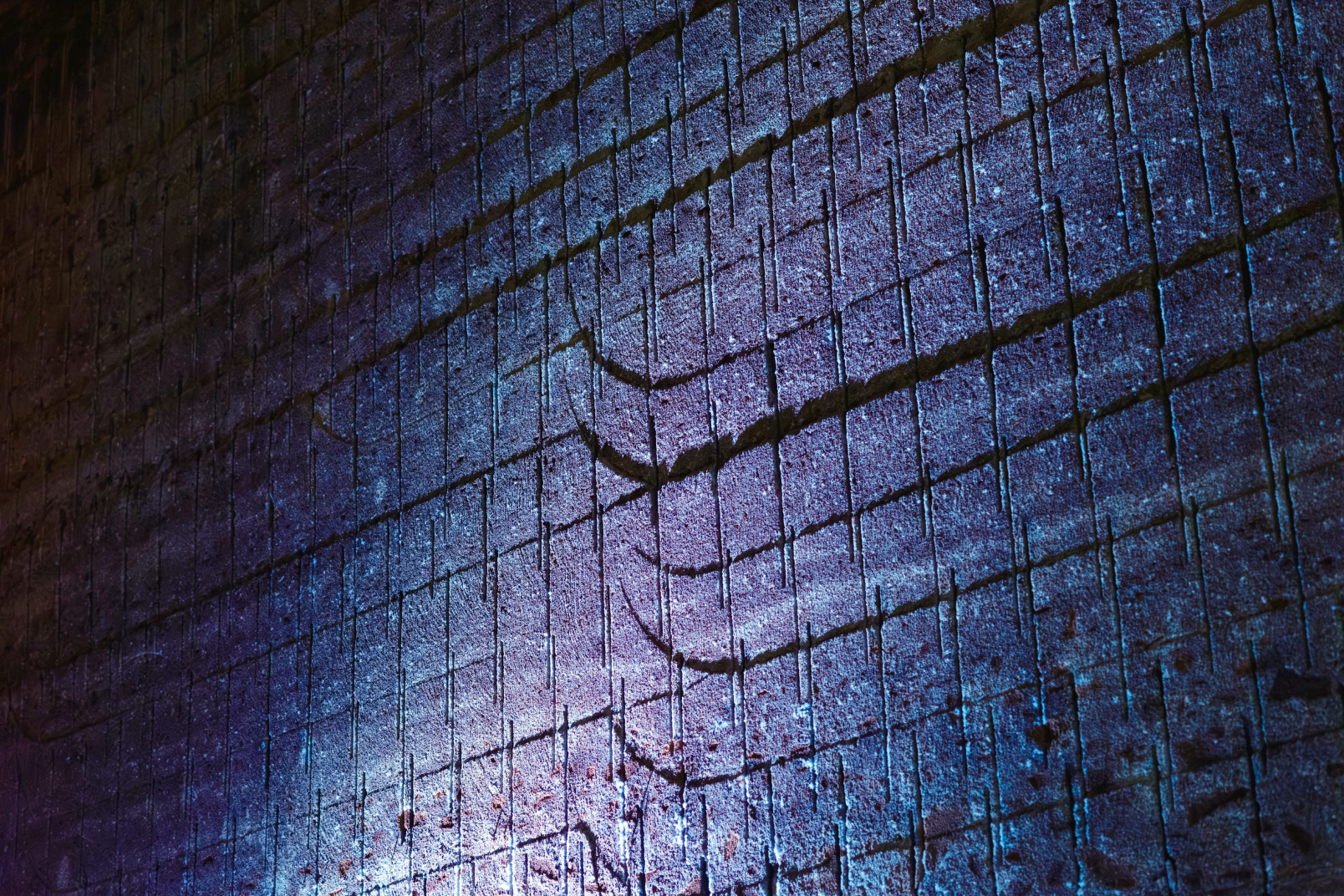 a blue brick wall with a blue light