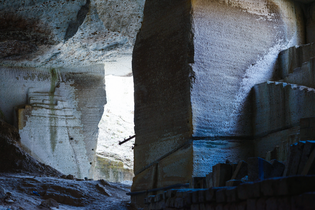 a stone structure with a light coming through