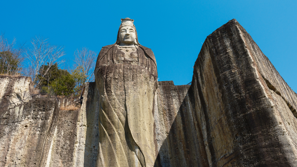 a statue of a woman on a rock