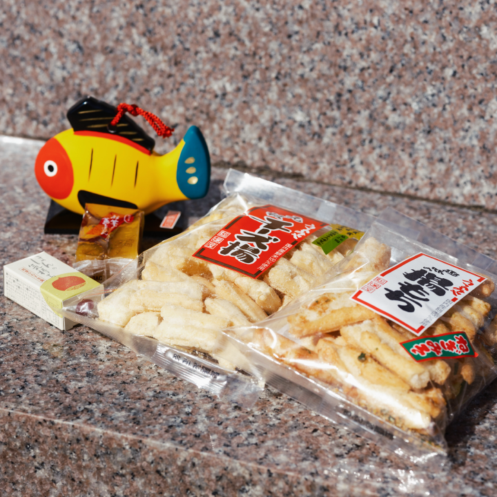 a fish shaped object next to bags of food