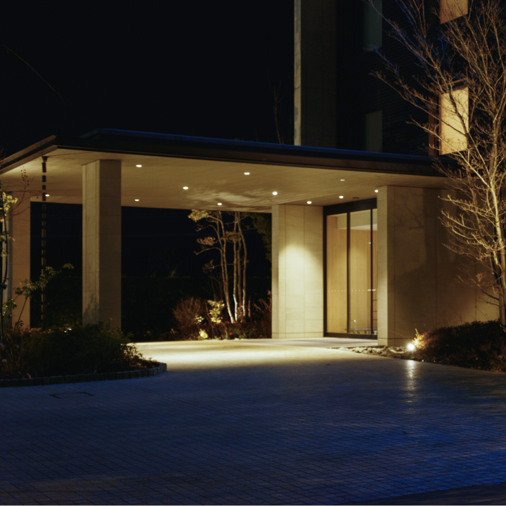 a building with a covered entryway at night
