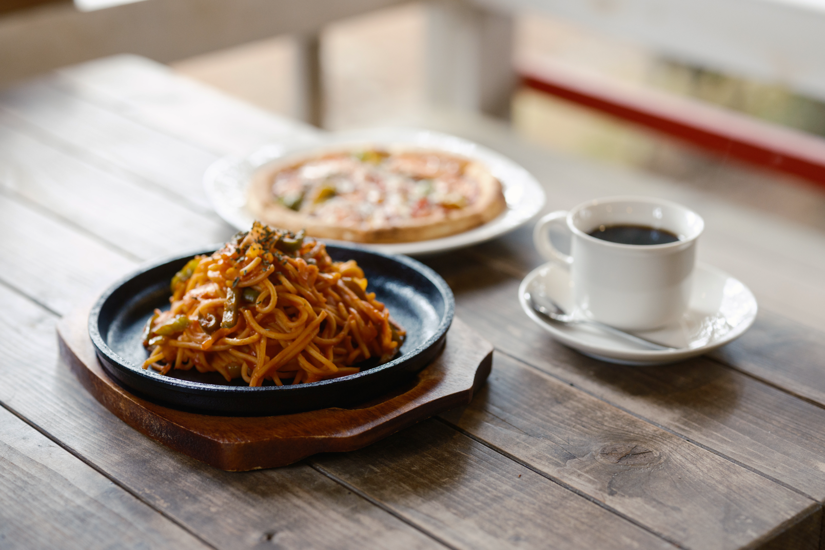 a plate of food and a cup of coffee on a table