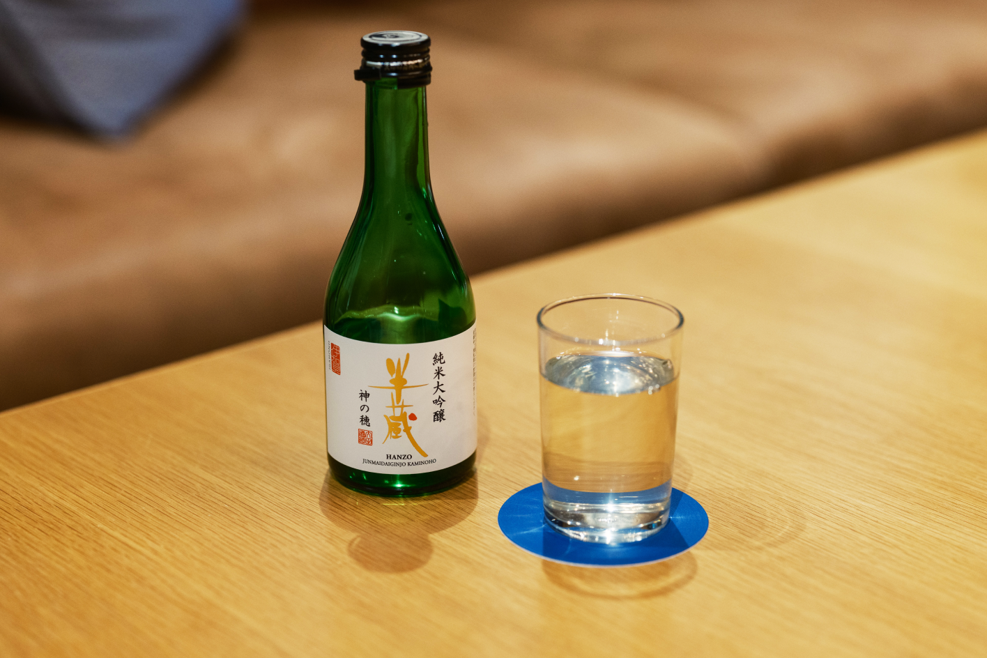 a glass of water next to a bottle