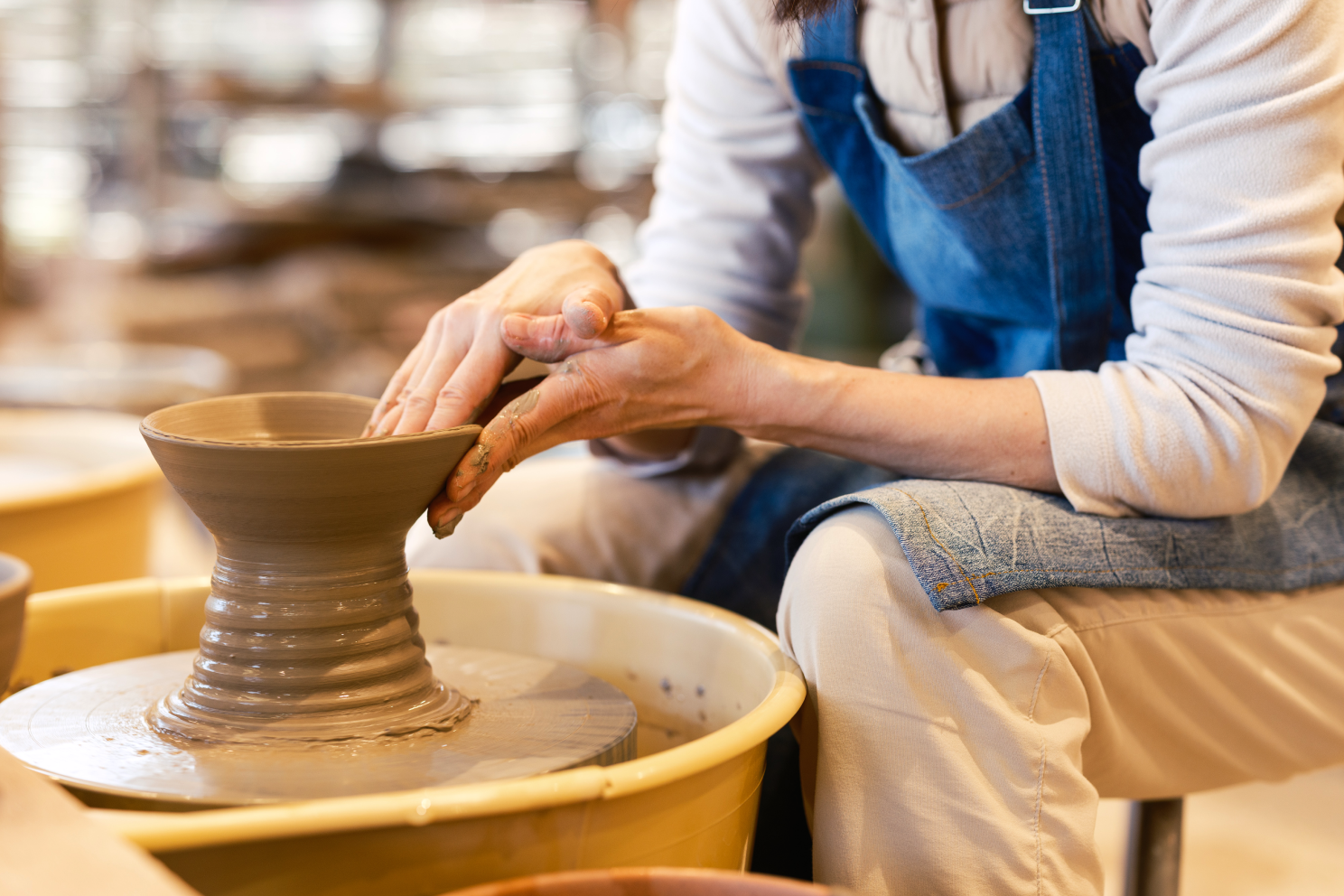 a person working on a pottery wheel