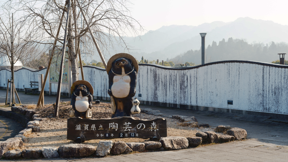a statue of two bears in front of a sign