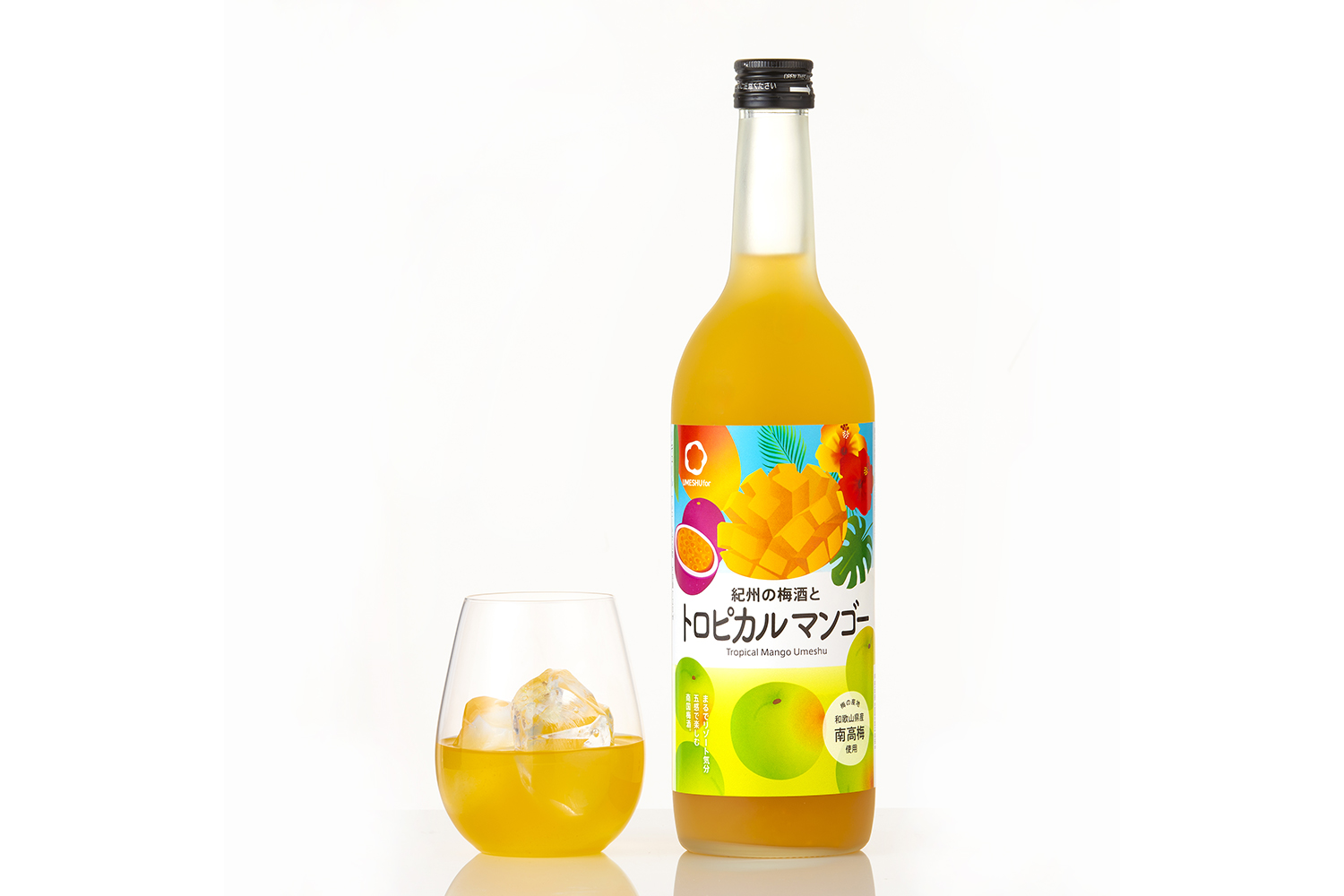 a bottle of yellow liquid next to a glass of yellow liquid