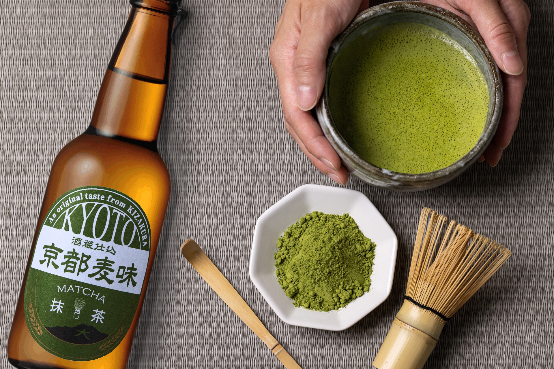 a hand holding a cup of green tea