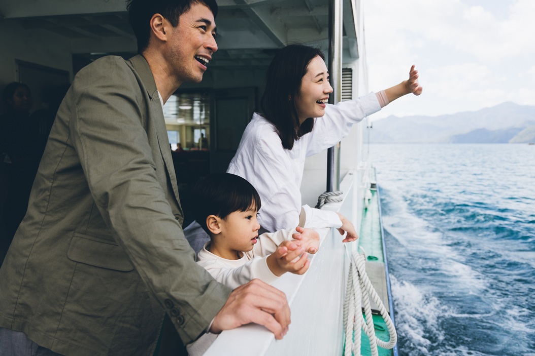 a man and woman looking out of a boat window