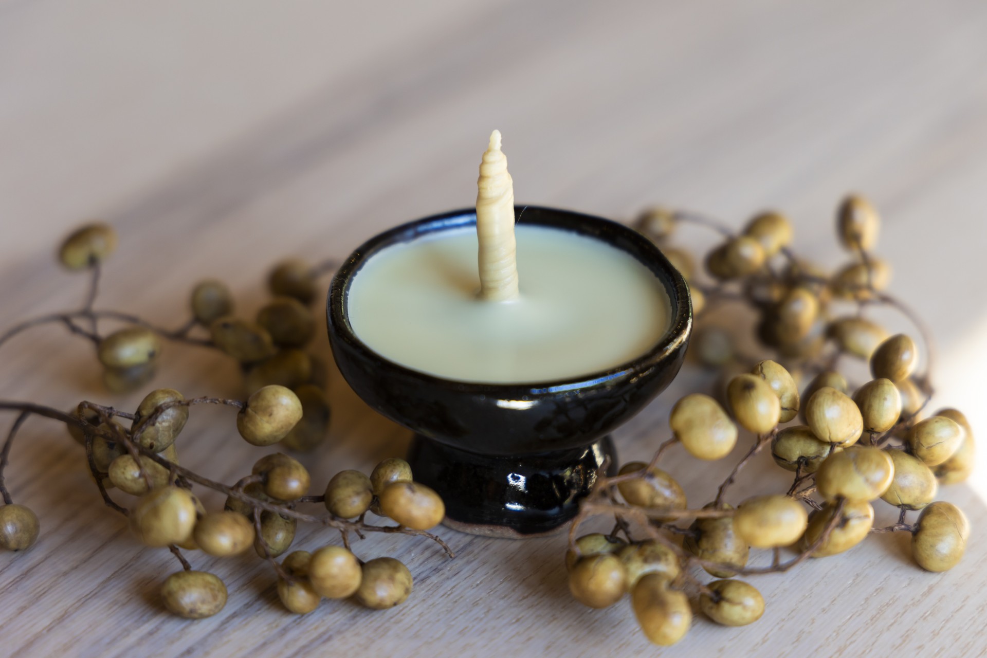a candle in a bowl with a candle in it