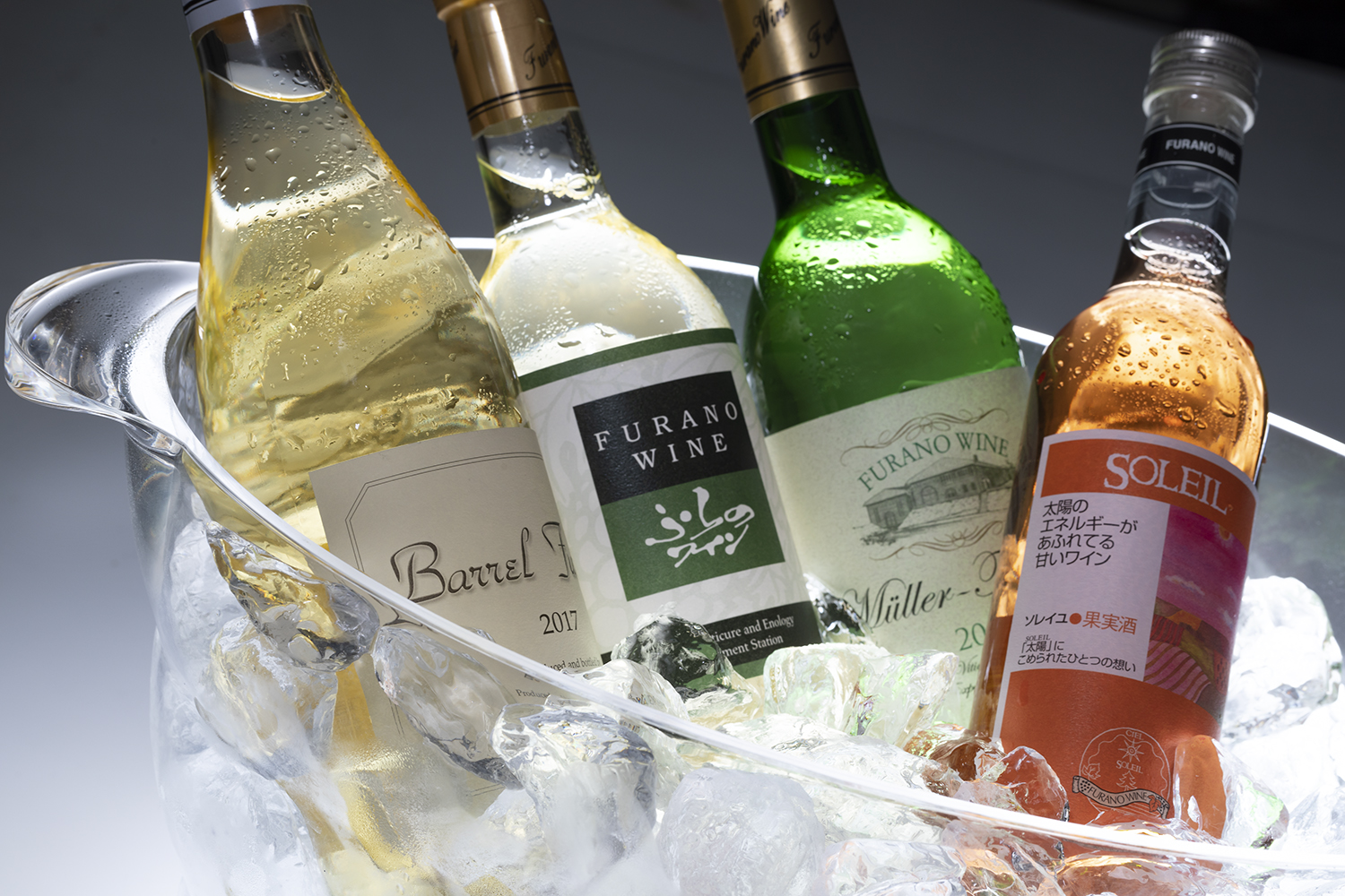 a group of bottles of wine in a bucket of ice