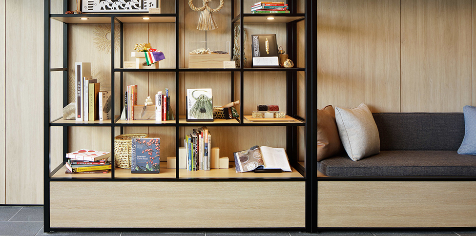 close up view of a bookshelf next to a bench in the library