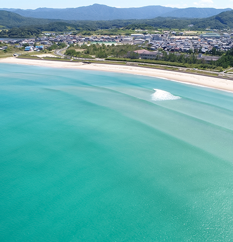 overhead view of beach with city in background