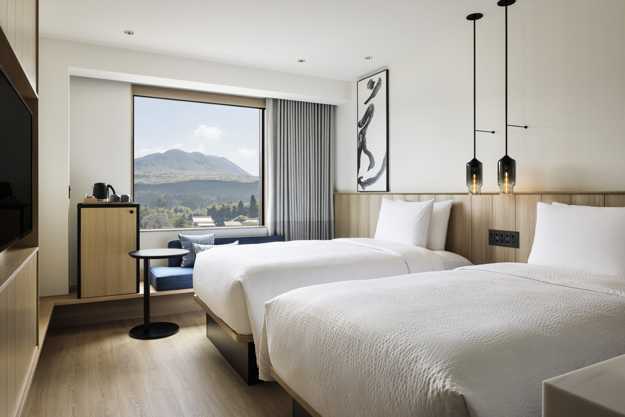 a room with two beds and a window