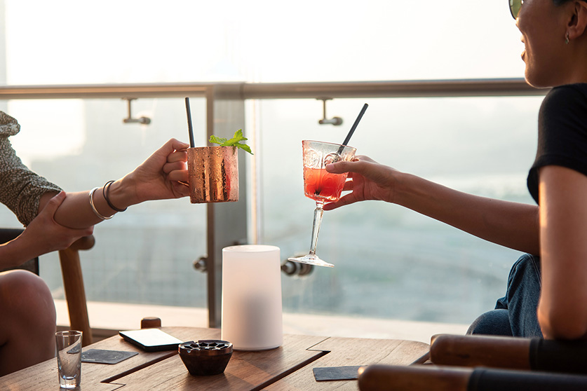 a couple of people holding drinks