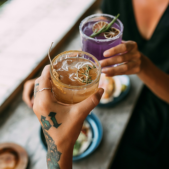 a person holding up a drink