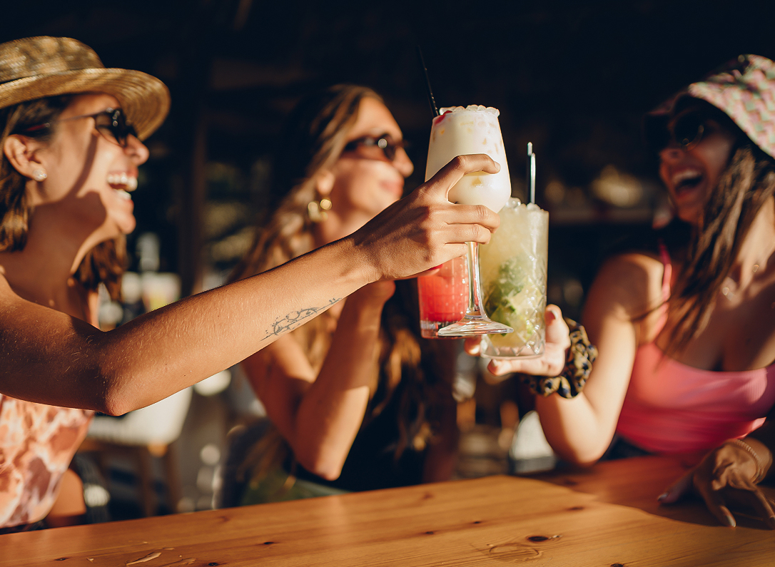 a group of women holding drinks