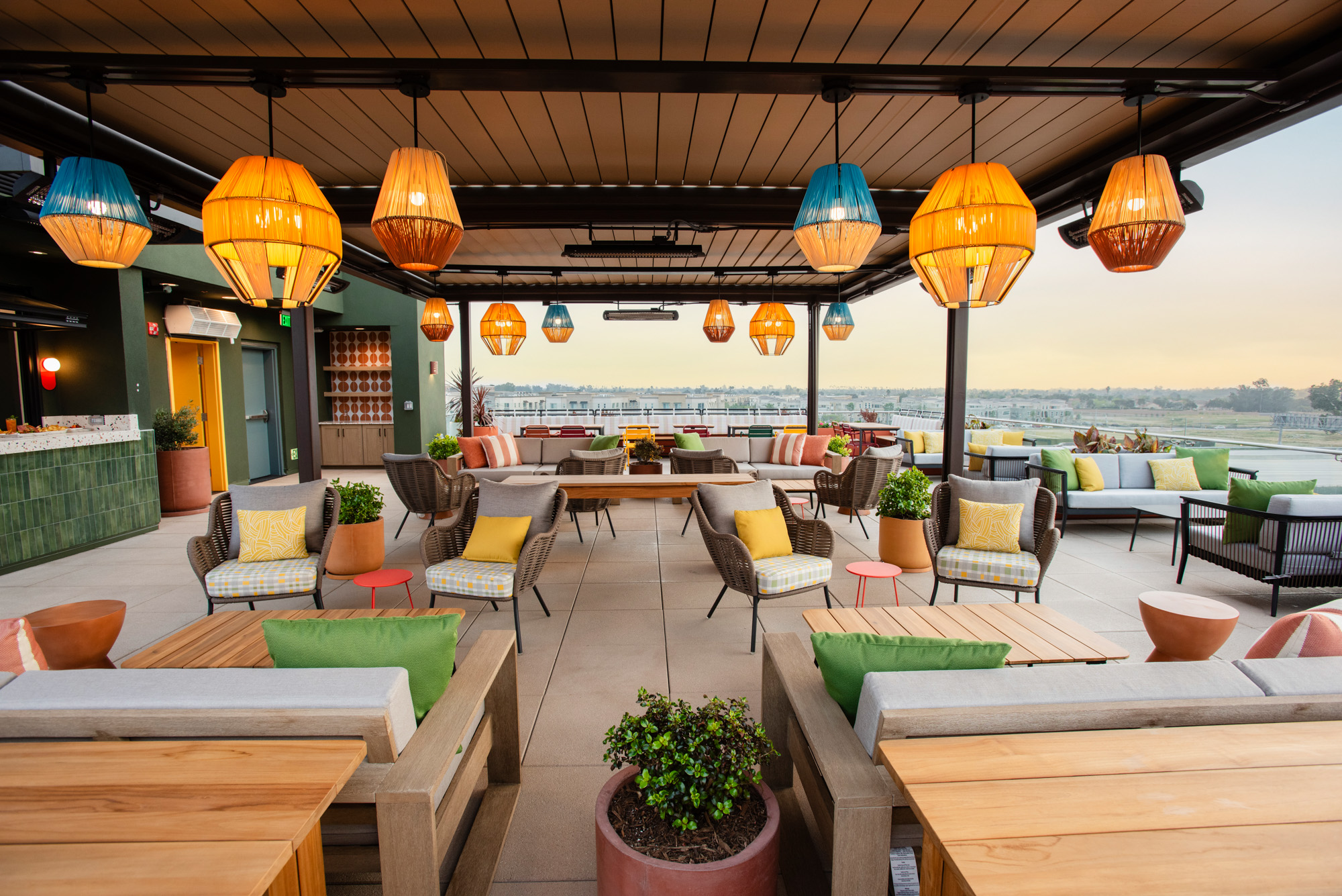 a patio with chairs and tables and lamps