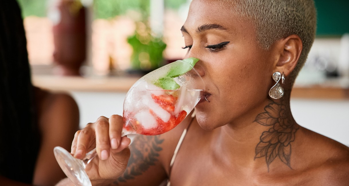 a woman drinking from a glass