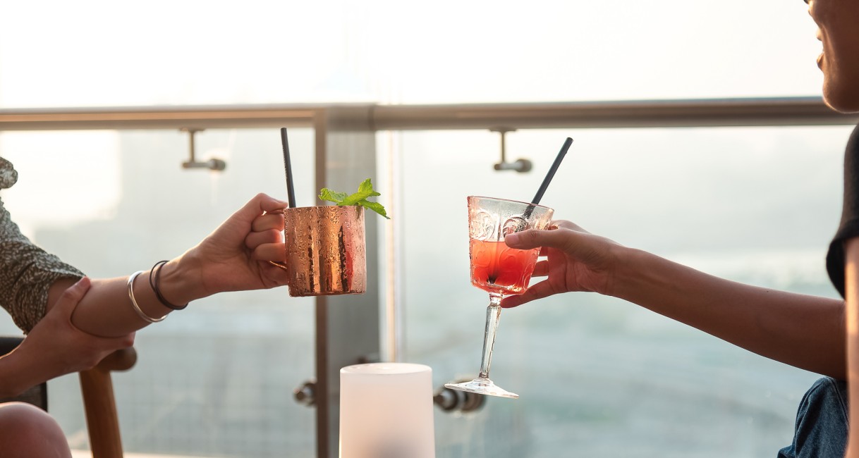 a pair of hands holding drinks