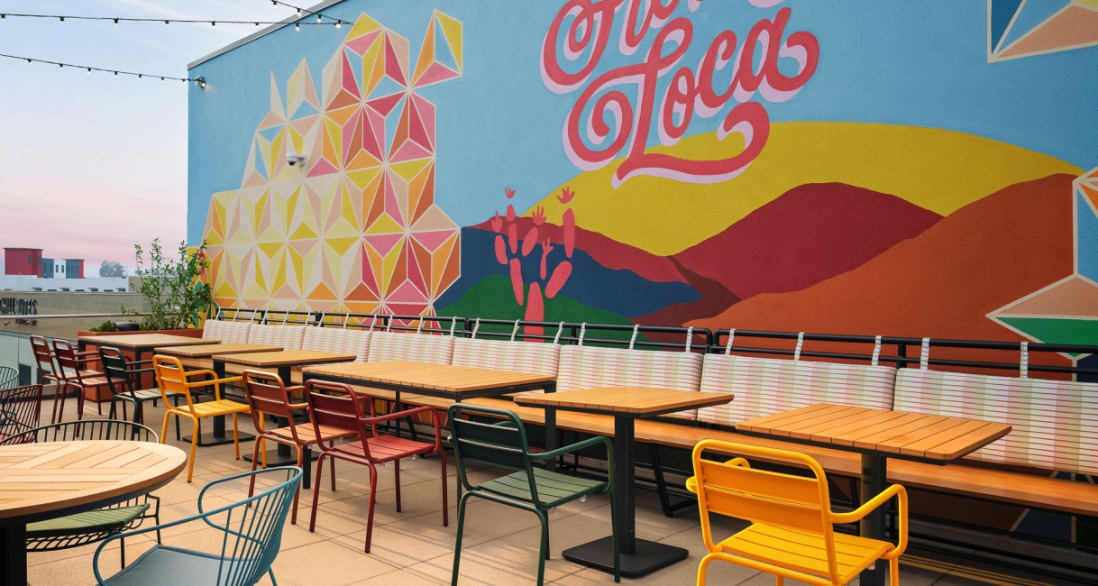 a colorful tables and chairs outside a building