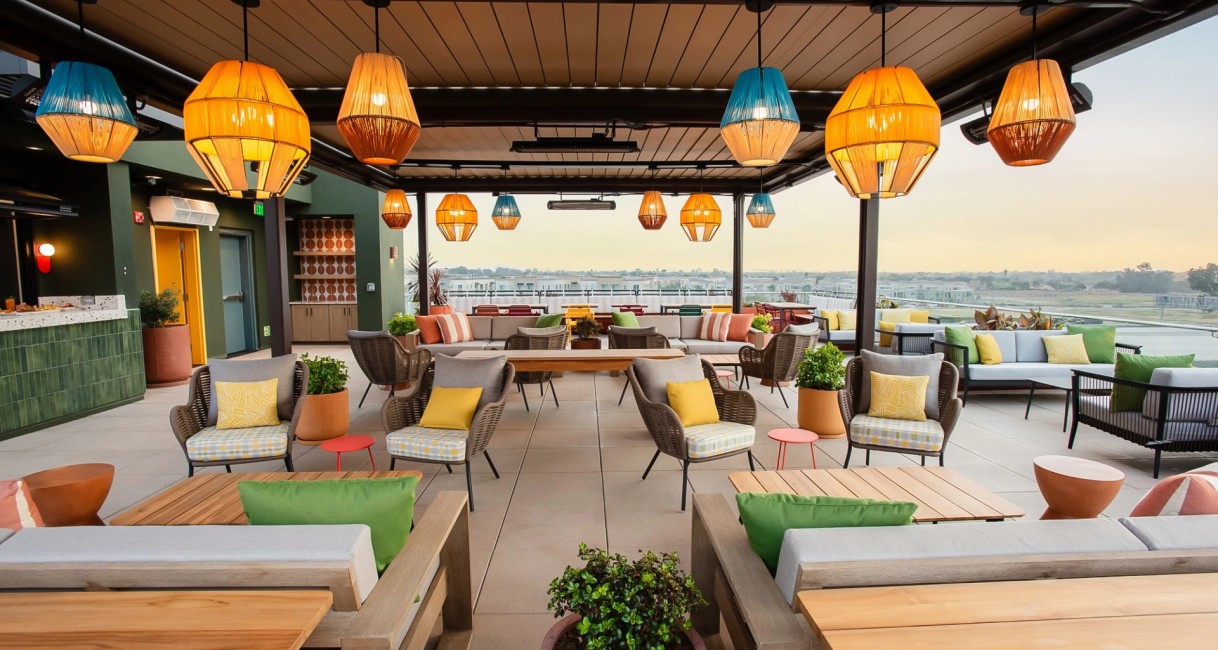 a patio with chairs and tables and lamps