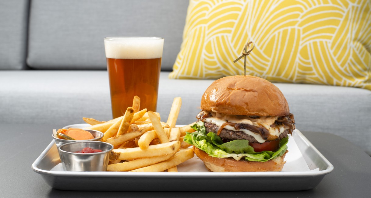 a plate of food with a drink and a glass of beer