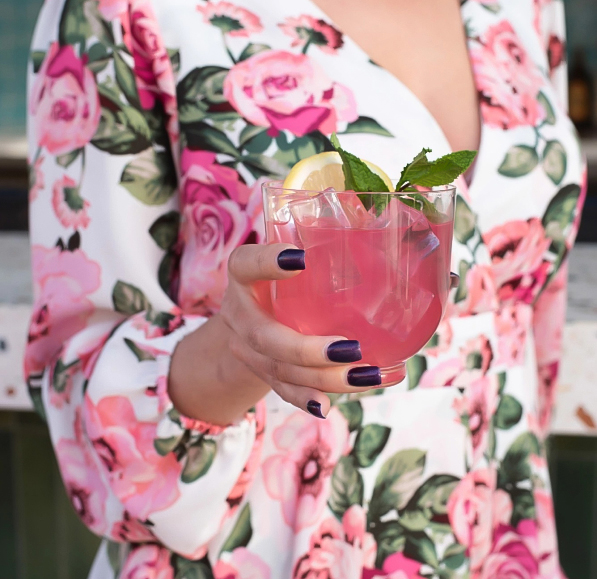 a woman holding a drink
