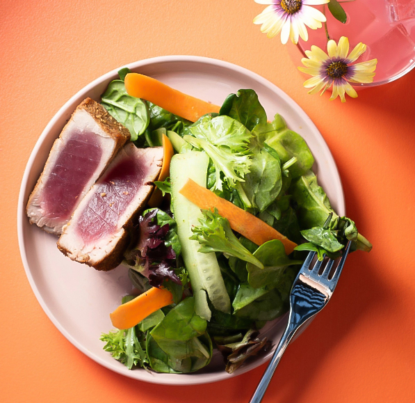 a plate of salad and meat