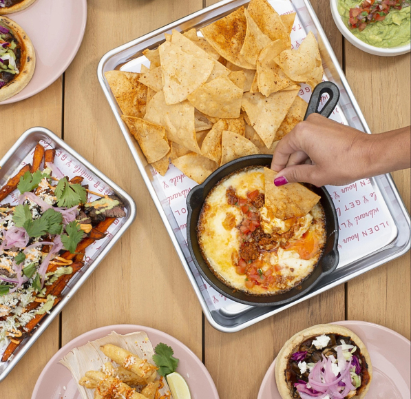 a person holding a pan of food