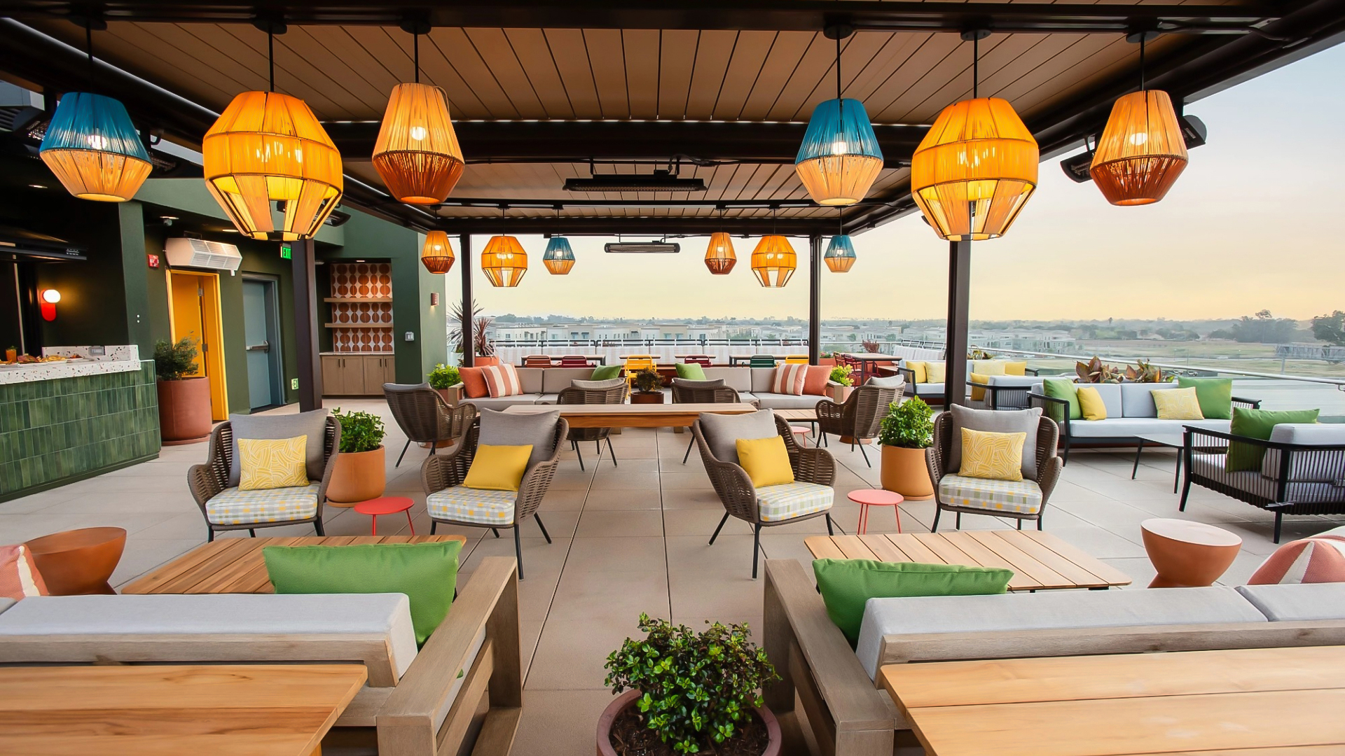 a patio with chairs and tables and lamps