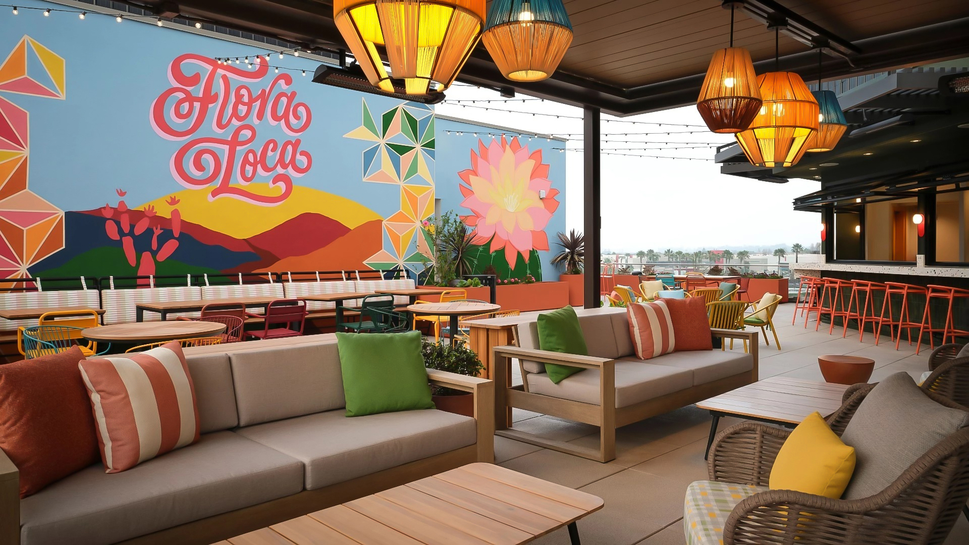 a patio with couches and tables and lamps