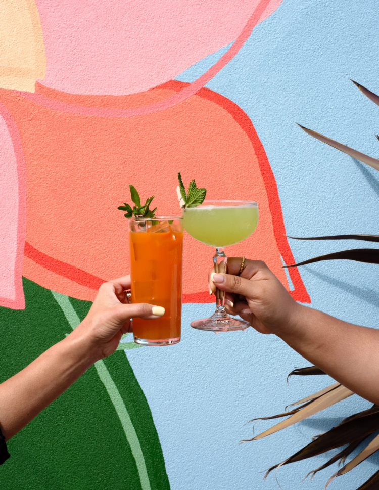 a pair of hands holding drinks