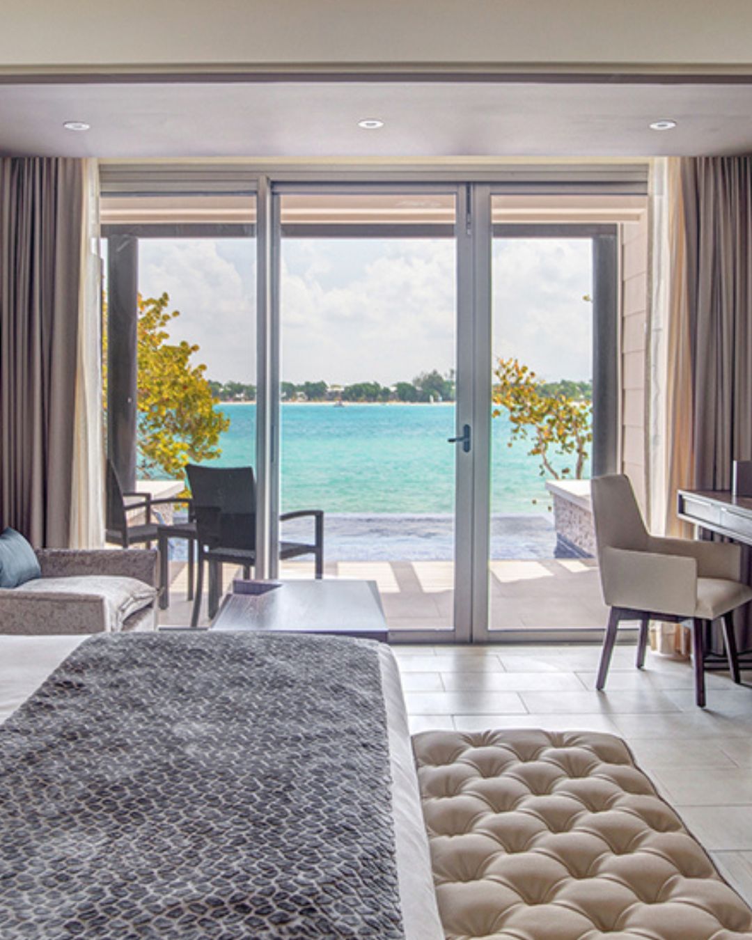 a room with a bed and a piano and chairs