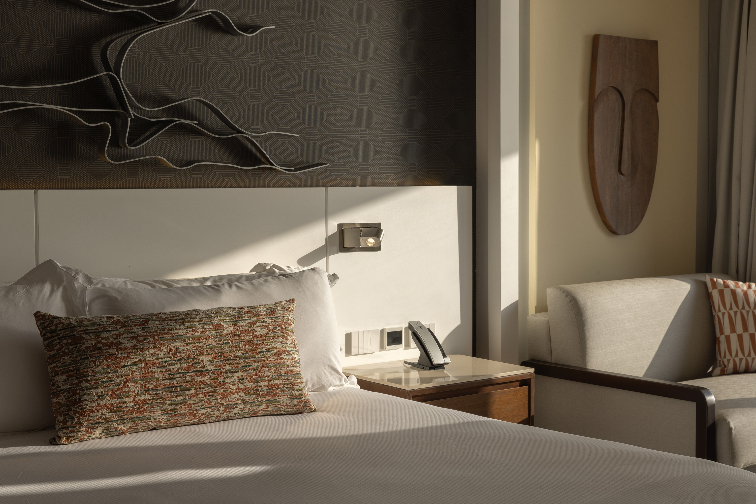 a bed with a phone on the side of it