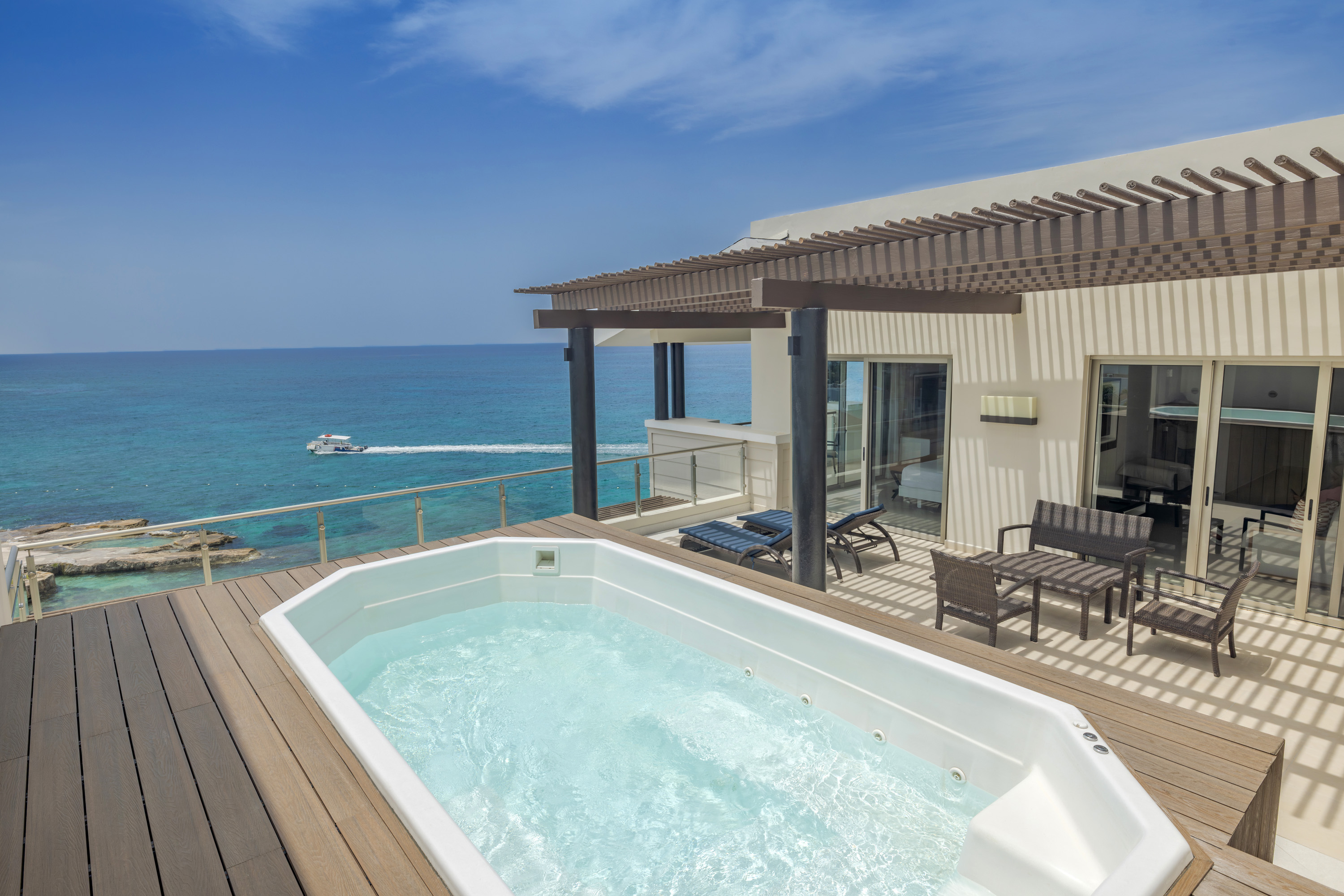 a hot tub on a deck overlooking the ocean