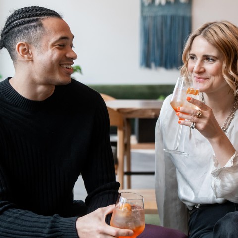 a man and woman holding drinks