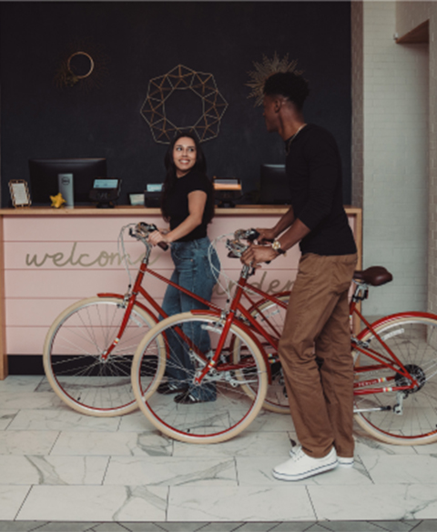 a man and woman standing next to bicycles