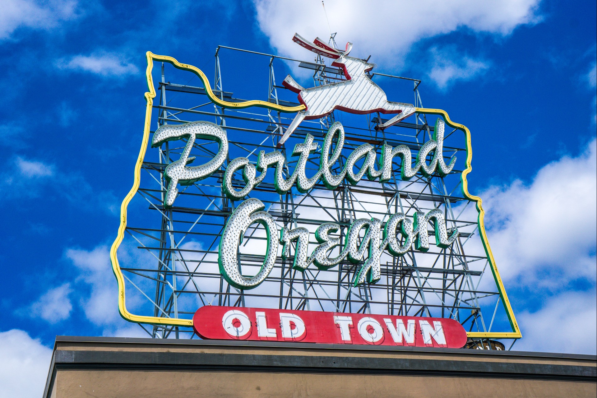 a large neon sign with a deer on top of it