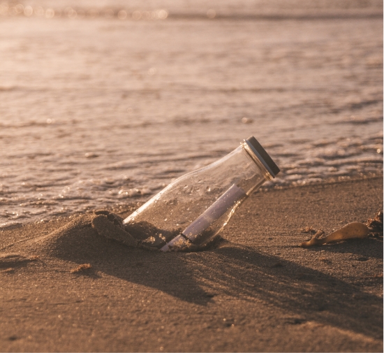 a bottle with a message in it on a beach