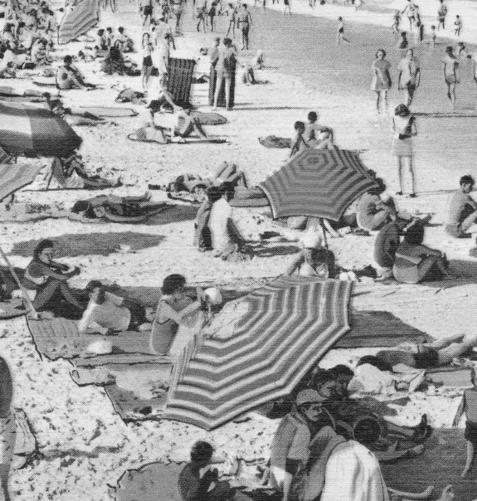 a black and white photo of people on a beach
