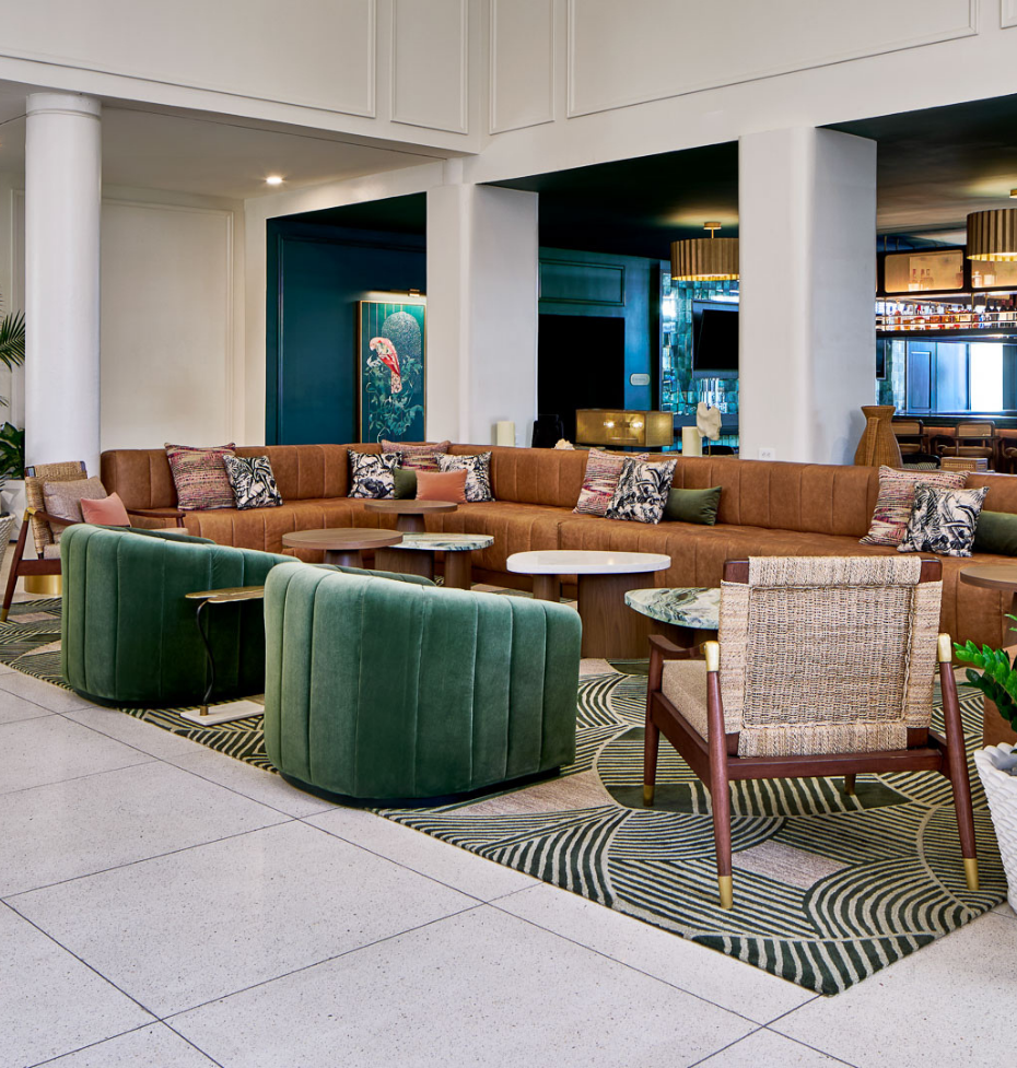 a large lounge area with a large couch and chairs